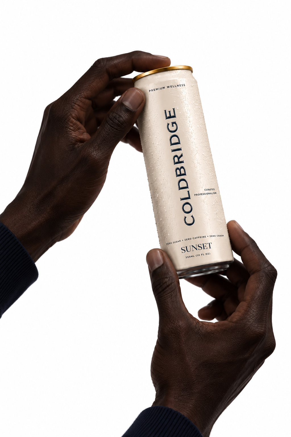 COLDBRIDGE SUNSET can held in hands with navy sleeves against a white background